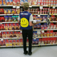 A Walmart employee stocks shelves in front of a slate of bakery items.